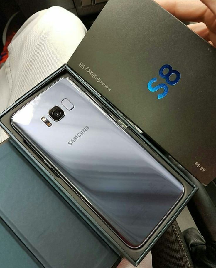 two samsung phones sitting next to each other on top of a box in someone's lap