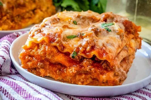 lasagna casserole with meat and cheese on a white plate