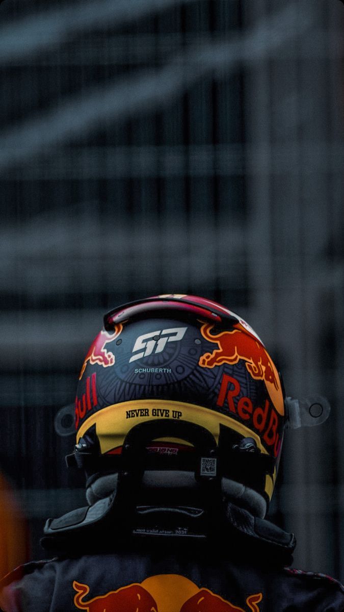 a red bull helmet is seen on the back of a man