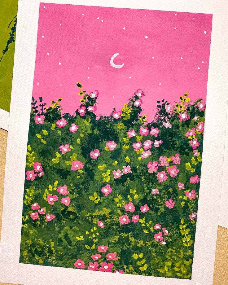 some pink flowers and green grass with a moon in the sky