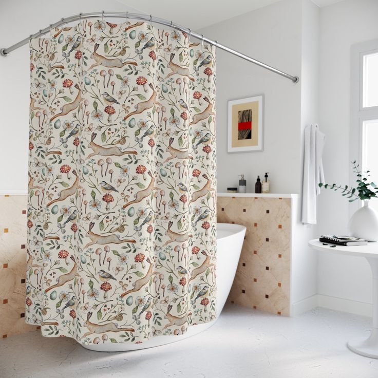 a bathroom with a bathtub, sink and shower curtain that has birds on it