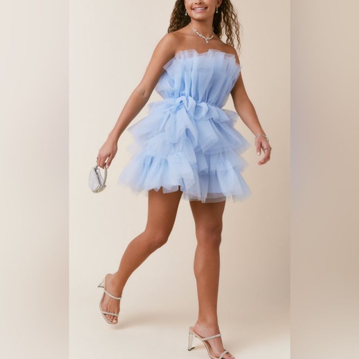 - Mini Dress - Tulle Tiered - Above Knee - Off Shoulder - Waisted - Models Are Approximately 5’10” And Wear A Size Small. - Imported. Blue Tulle Wedding Dress, Blue Organza Prom Dress, Blue Ruffled Mini Dress For Homecoming, Blue Sleeveless Organza Dress, Blue Organza Sleeveless Dress, Light Blue Organza Dress With Ruffles, Blue Tulle Mini Dress For Wedding, Chic Blue Organza Dress, Blue Mini Tulle Dresses