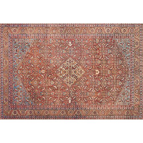 an antique persian rug with red, orange and blue colors on the ground is shown