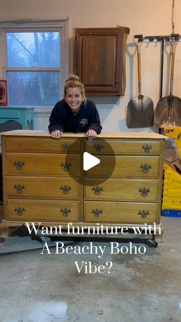 a woman standing behind a dresser in a garage