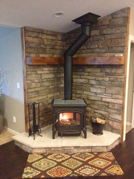 a wood burning stove sitting inside of a living room next to a wall with shelves