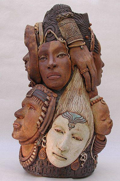 a ceramic figurine with three faces on it