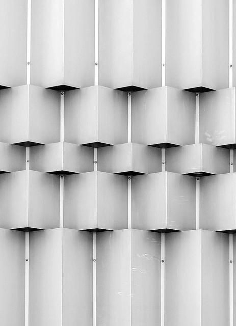 a black and white photo of a wall made out of cubes