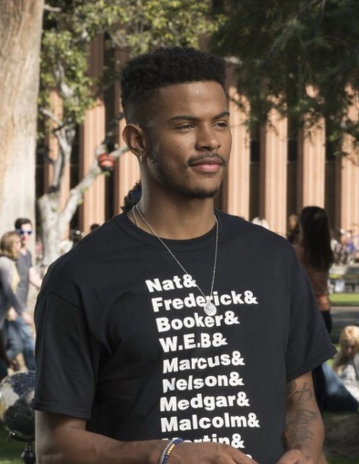 a man in a black shirt is holding a frisbee