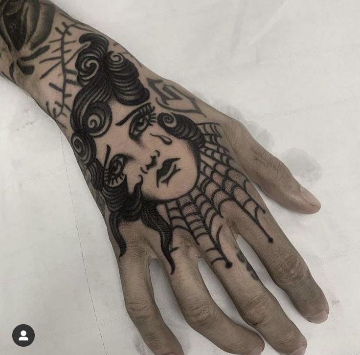 a person's hand with a tattoo on it