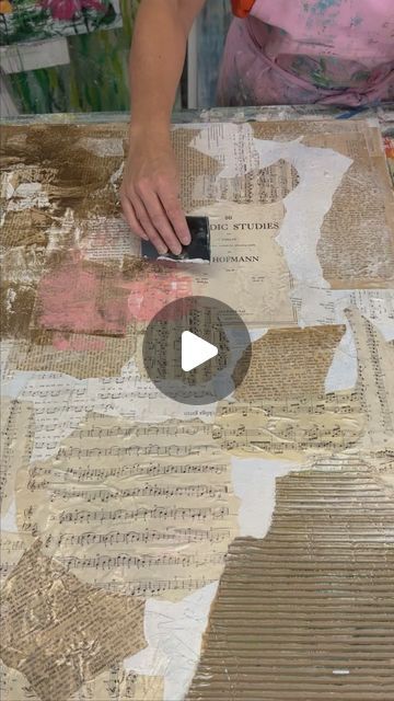 a woman is making art with old newspaper