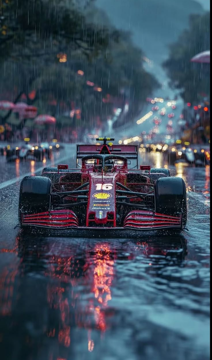 a red race car driving through the rain on a city street in the pouring rain