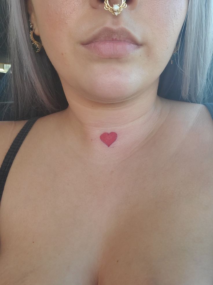 a close up of a woman's face with a nose ring on her nose