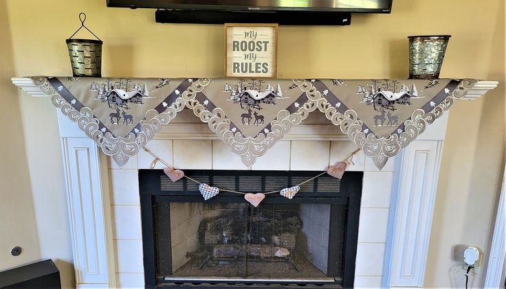 a living room with a fire place and mantle decorated for halloween time, including decorations