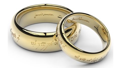 two gold wedding rings with names engraved on them