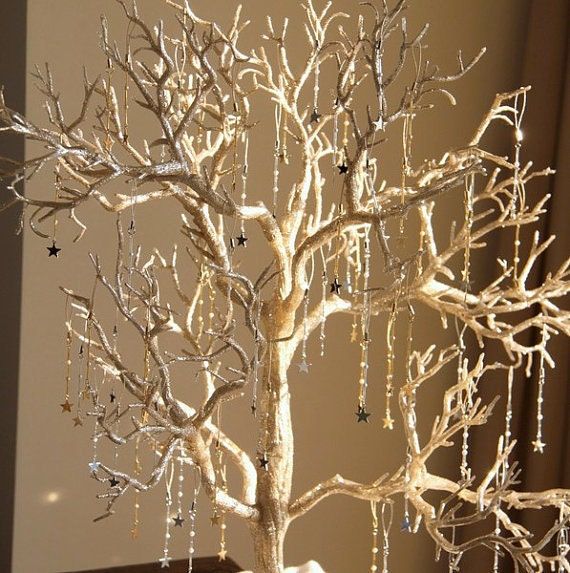 a white tree with beads hanging from it's branches