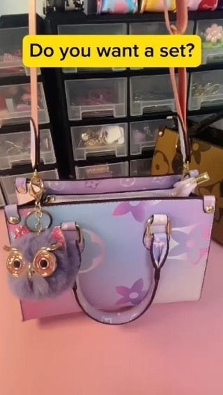 a handbag sitting on top of a pink table