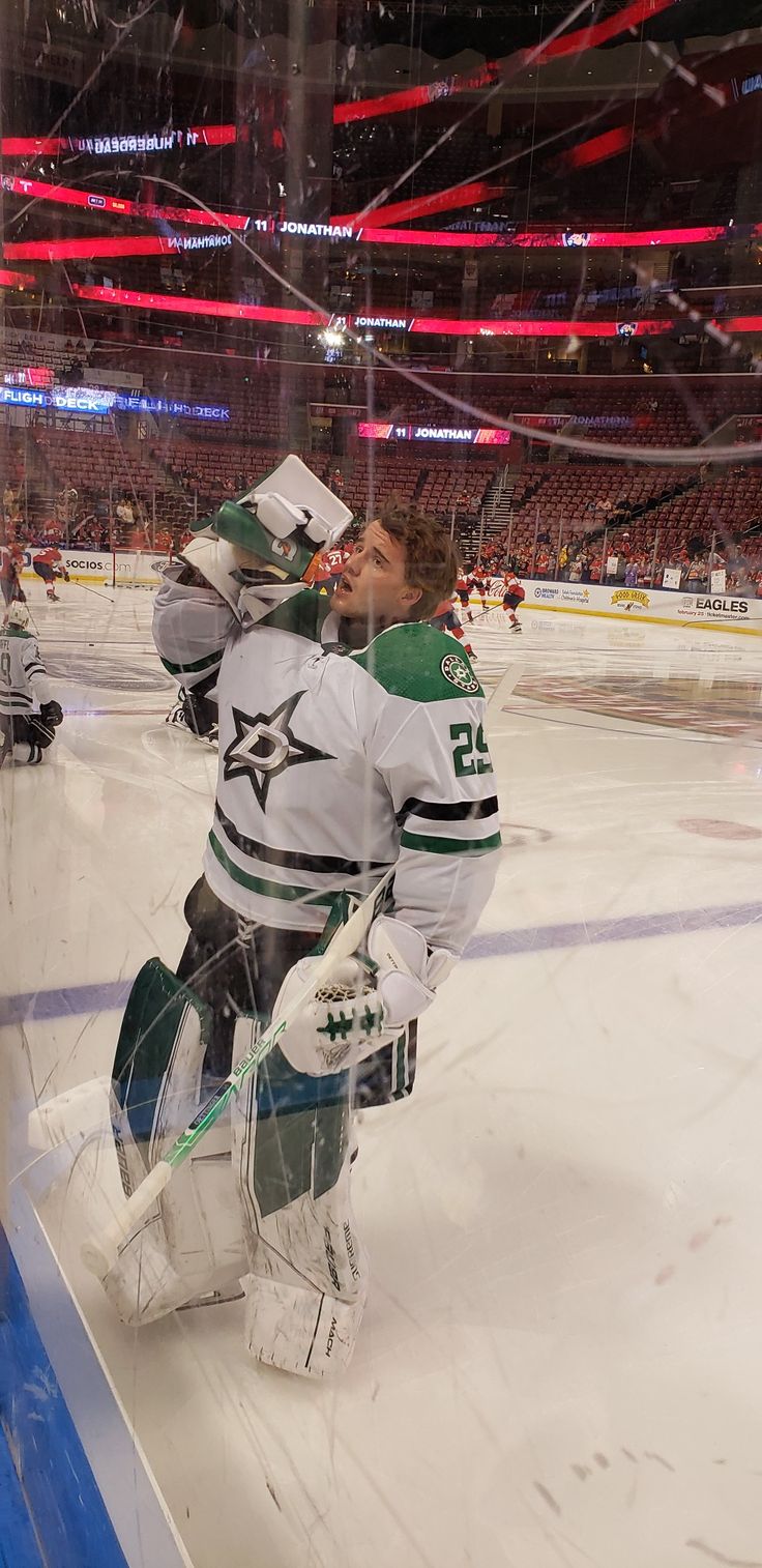 an image of a hockey goalie getting ready to go on the ice for his team