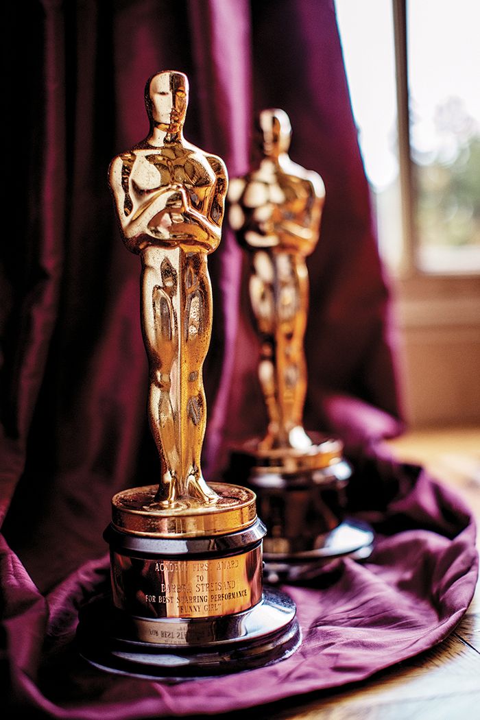 two oscar statues sitting on top of a table