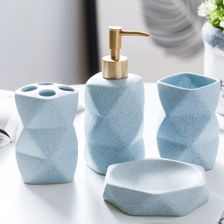 a bathroom set consisting of soap dispenser, toothbrush holder and soap dish