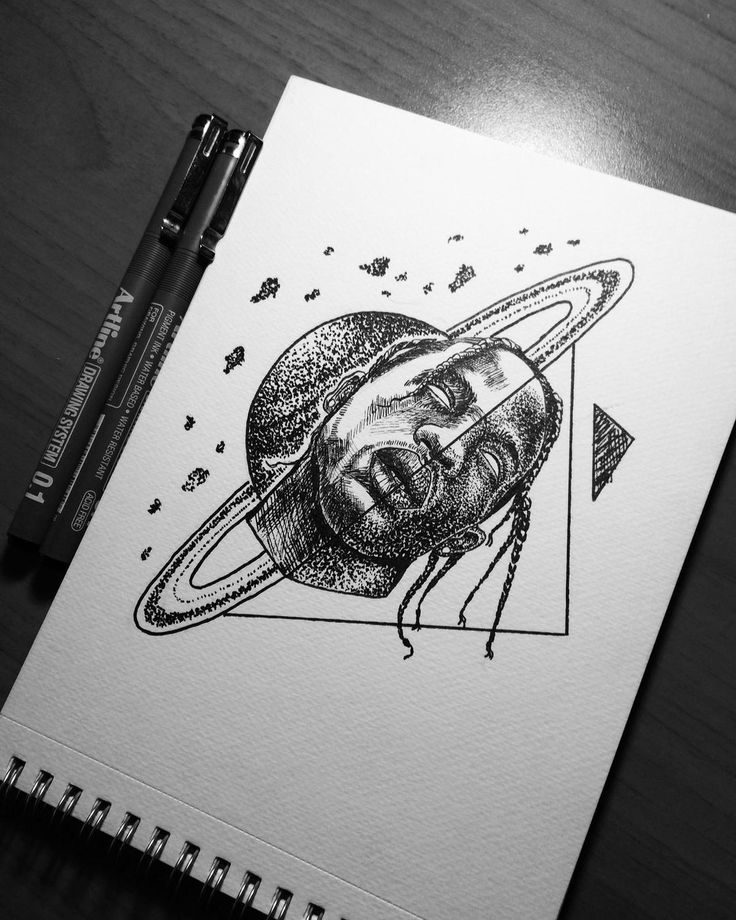 a pencil drawing of a man's face in the center of a space stationery notebook