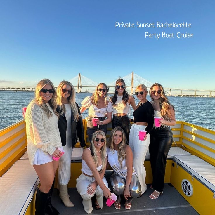 a group of women standing on the back of a boat