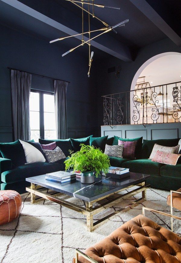 a living room filled with lots of green furniture