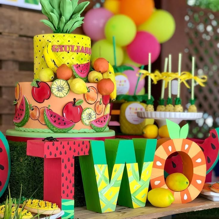 a table topped with lots of colorful cakes and desserts