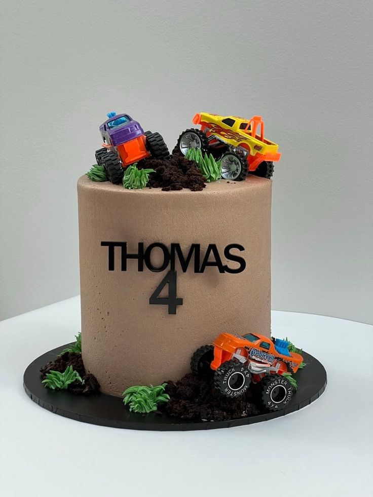 a birthday cake made to look like a monster truck with the number 4 on it