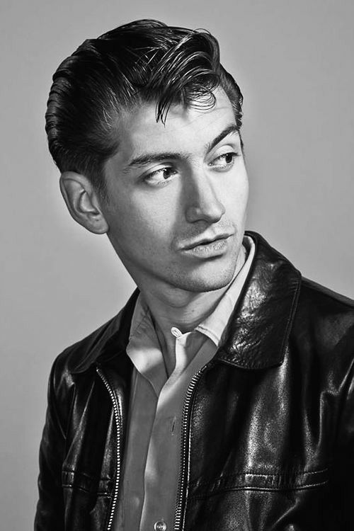 a black and white photo of a man in a leather jacket