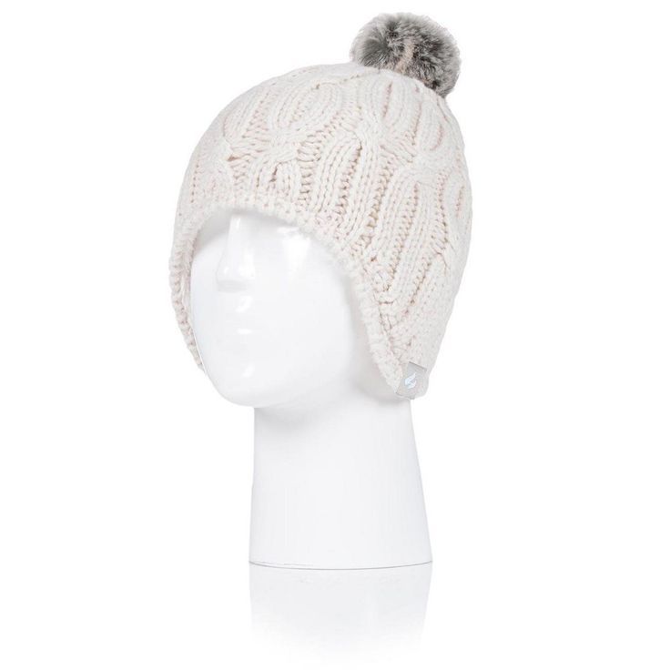 Wrap yourself in warmth with the Heat Holders Women's Nikki Cosy Ears Hat, a must-have accessory for chilly days. This stylish hat features:

- Size: One Size
- Color: Buttercream
- Gender: Female
- Material: High performance thermal yarn with HeatWeaver® insulation lining

Designed to keep you exceptionally warm, the Nikki Cosy Ears hat is equipped with a plush HeatWeaver® insulation lining that traps heat efficiently, ensuring your comfort during cold weather. The charming faux fur pom-pom add Adjustable Brimmed Beanie For Cold Weather, Adjustable Beige Beanie For Winter, Cozy Adjustable Hats With Ear Flaps, Cozy Adjustable Ear Flap Hats, Winter Cream Bonnet Cap, Cream Winter Bonnet Cap, Winter Cream Bonnet, White Winter Hats With Ear Flaps, Adjustable Knitted Cream Beanie