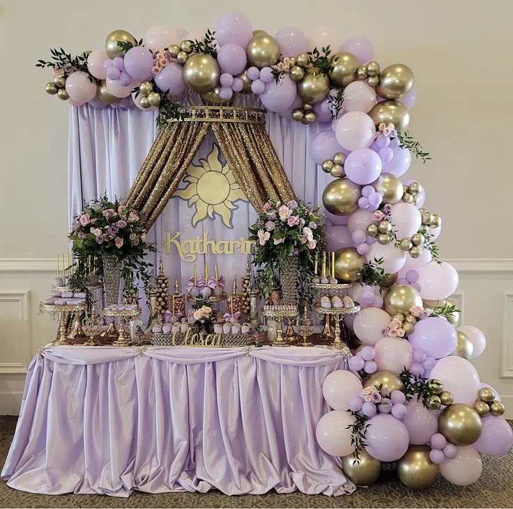 a purple and gold birthday party with balloons