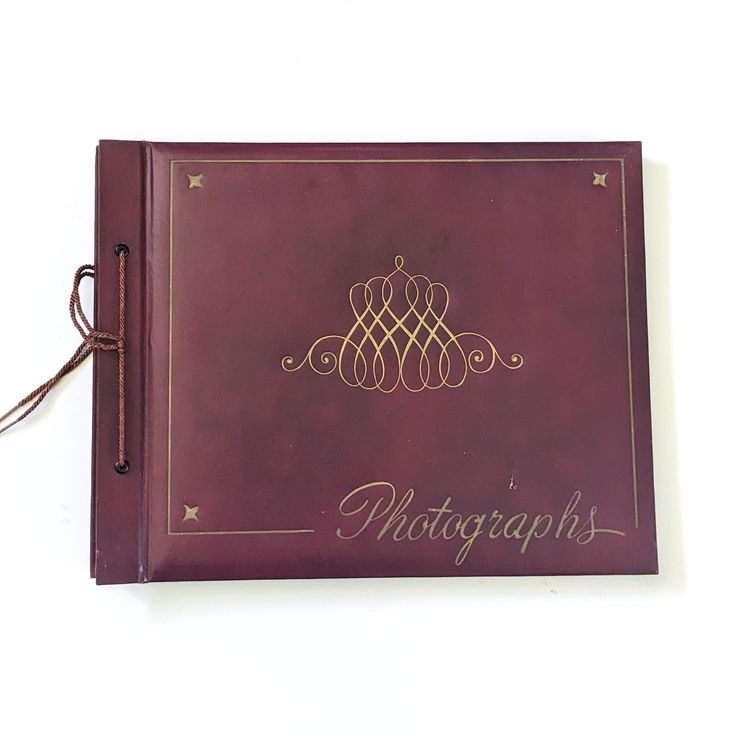 a red book with writing on the front and back cover that says photography in gold lettering