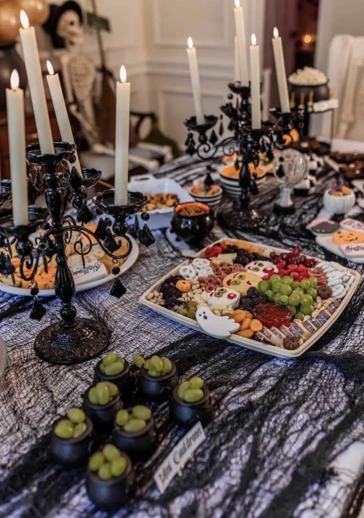 a table topped with lots of food and candles