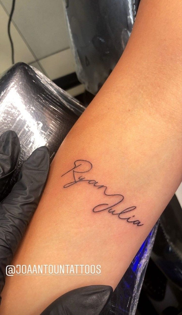 a woman with a tattoo on her arm that says,'brave'in cursive writing