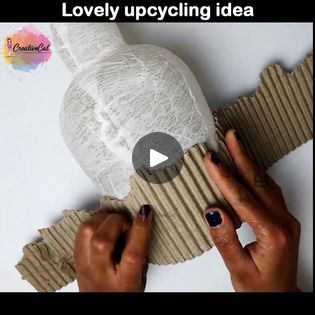 two hands are working on an object made out of cardboard and paper with the words lovely upcycling idea