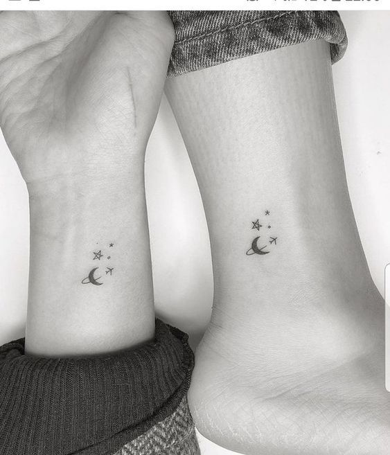 two people with matching tattoos on their wrist