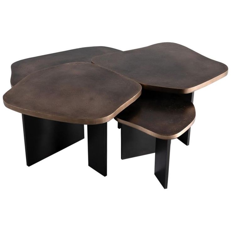 two tables made out of concrete with black legs