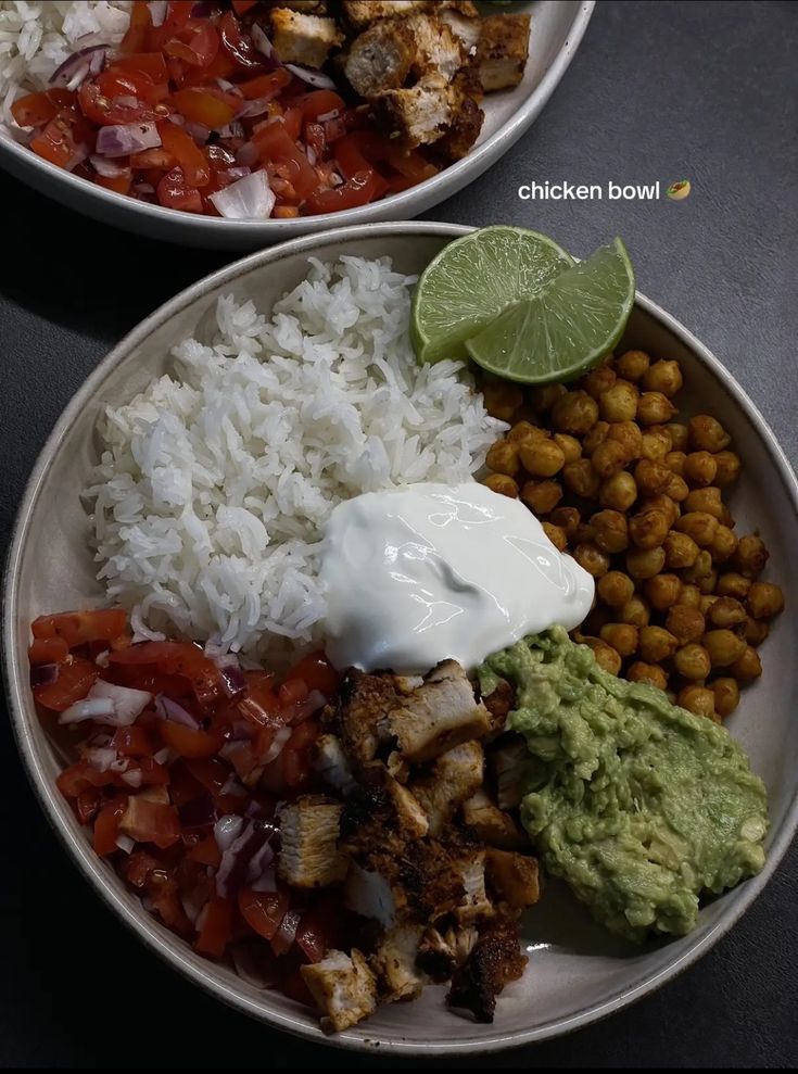 two white plates filled with different types of food and garnished with sour cream