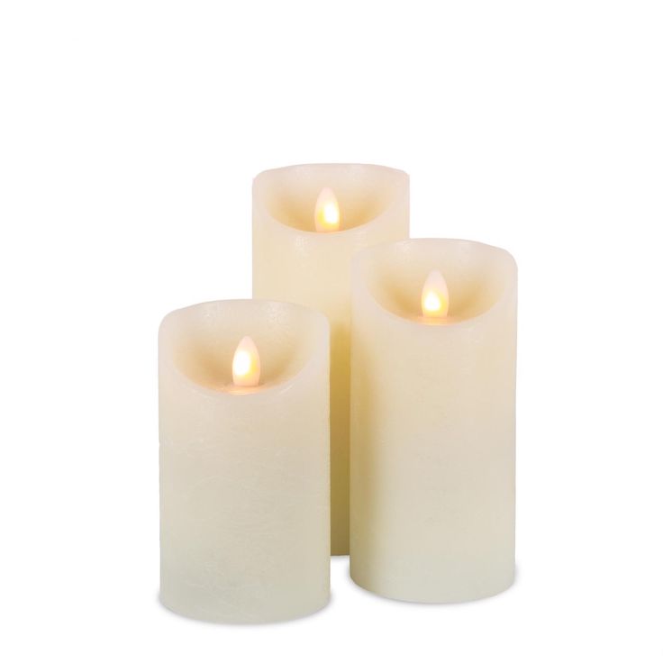 three white candles sitting next to each other