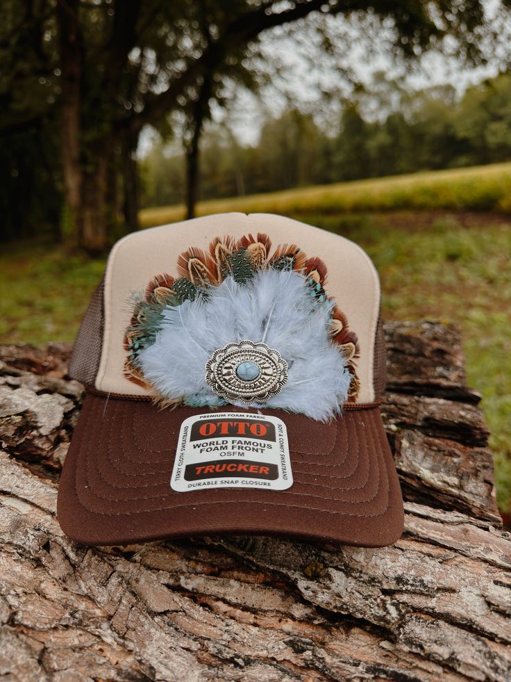 At FeatheredHavenCo, we pride ourself in our unique and fashionable designs . Our hats and apparel are crafted with premium materials and attention to detail, ensuring a timeless look that's both stylish and durable. From ranchers to rodeo riders, outdoor enthusiasts to fashion enthusiasts, our feather-adorned designs bring a touch of Western charm to any wardrobe. Adjustable Brown Baseball Cap For Rodeo, Brown Country Style Snapback Hat, Western Style Brown Adjustable Baseball Cap, Western Style Adjustable Brown Baseball Cap, Adjustable Brown Western Baseball Cap, Brown Adjustable Western Baseball Cap, Western Snapback Hat With Flat Brim, Western Style Brown Snapback Hat, Western Brown Snapback Hat