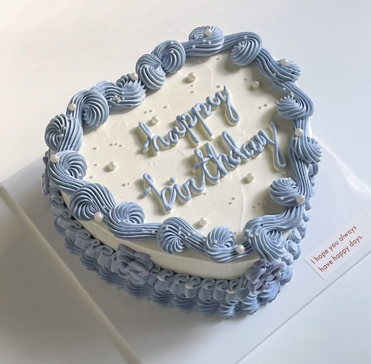 a blue and white birthday cake with the words happy birthday written in frosting on it