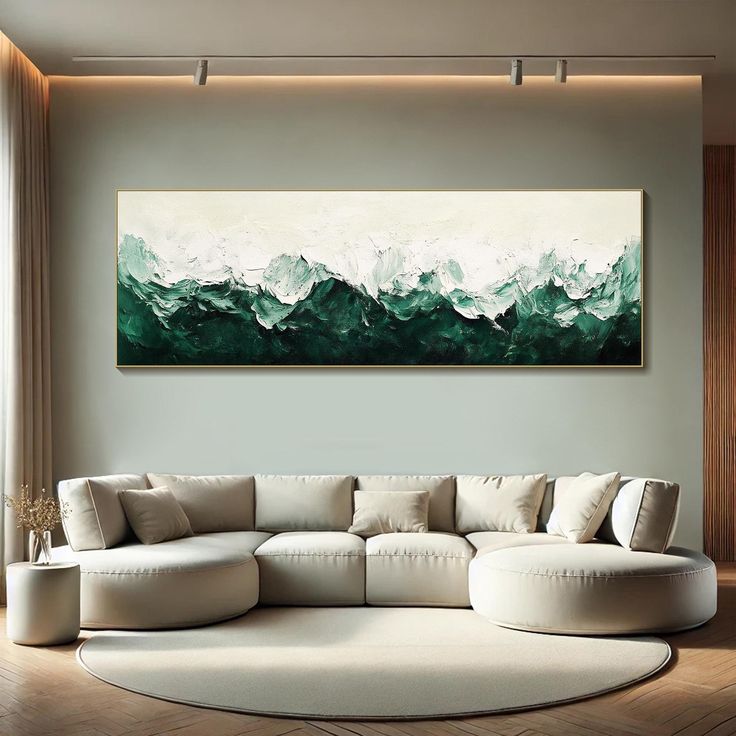 a living room with a large painting on the wall and a white couch in front of it