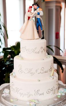 a wedding cake with a bride and groom figurine on top