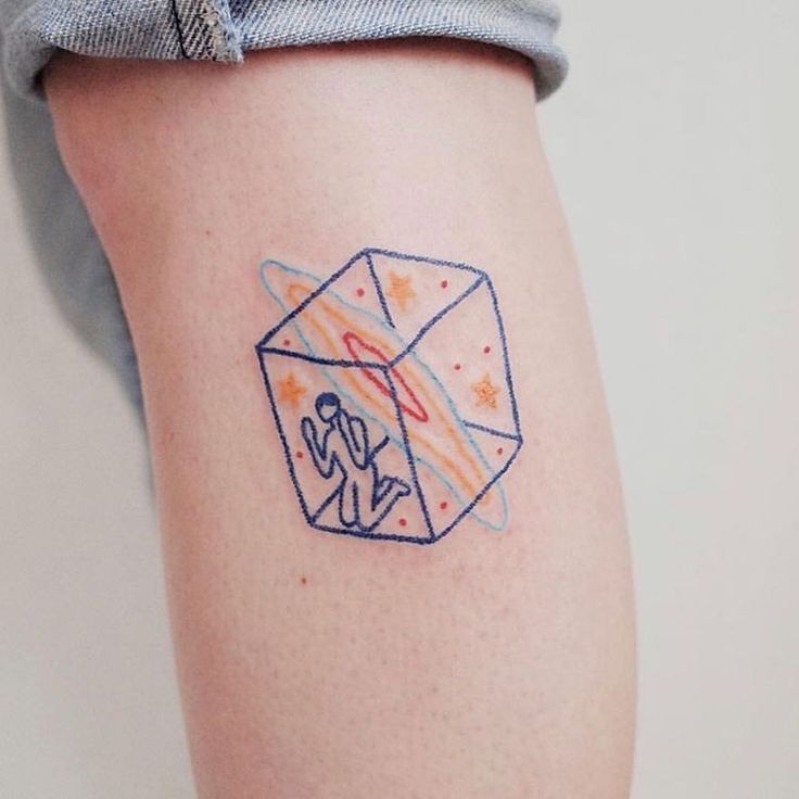 a person with a small tattoo on their arm that has an origami envelope in it