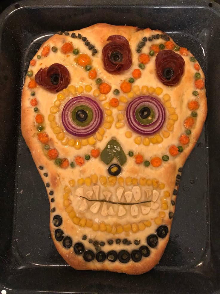 a decorated sugar skull sitting on top of a pan