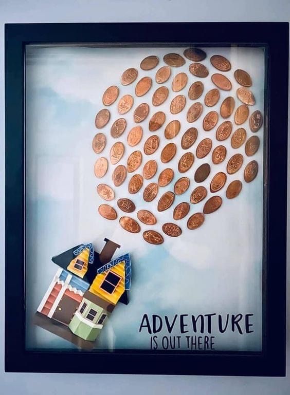 there is a picture frame that has some coins on it and the words adventure is out there