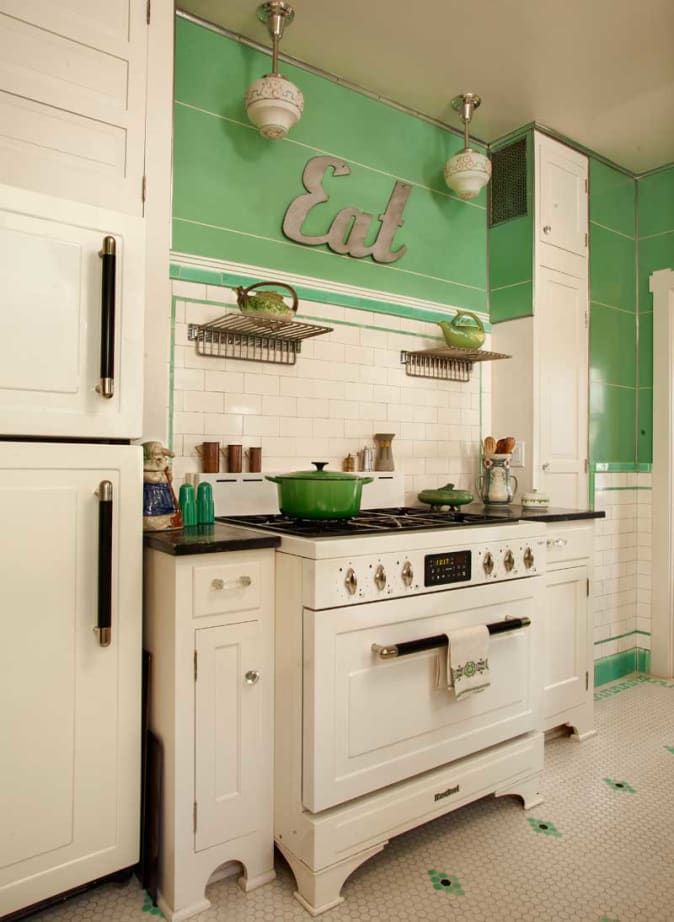 a white stove top oven sitting inside of a kitchen