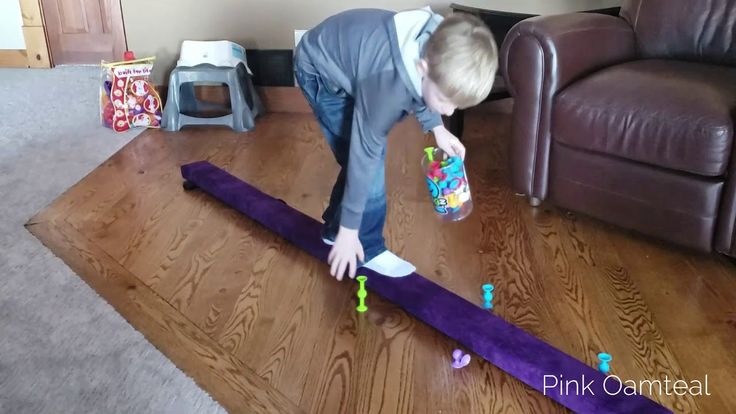 a little boy playing with toys on the floor