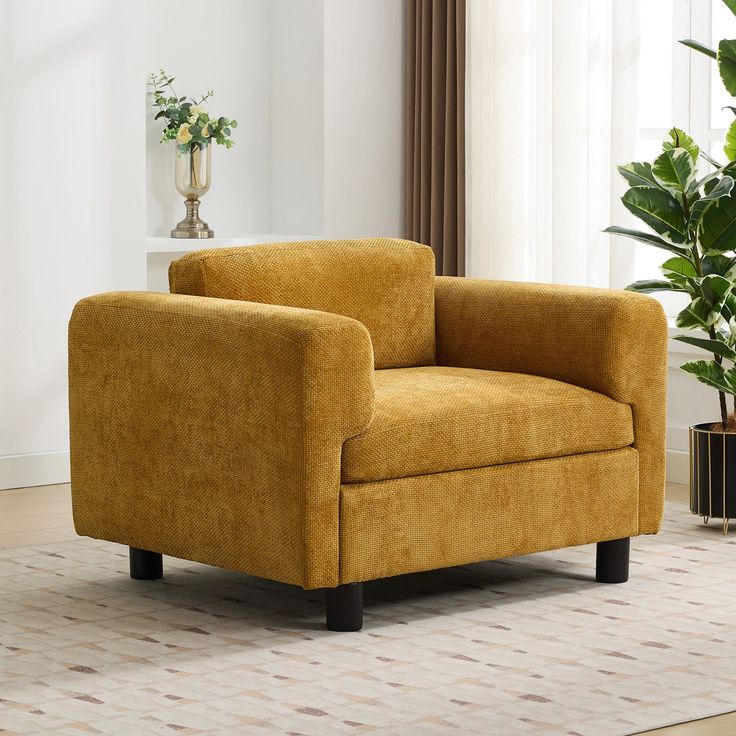 a yellow chair sitting on top of a rug in a living room next to a potted plant