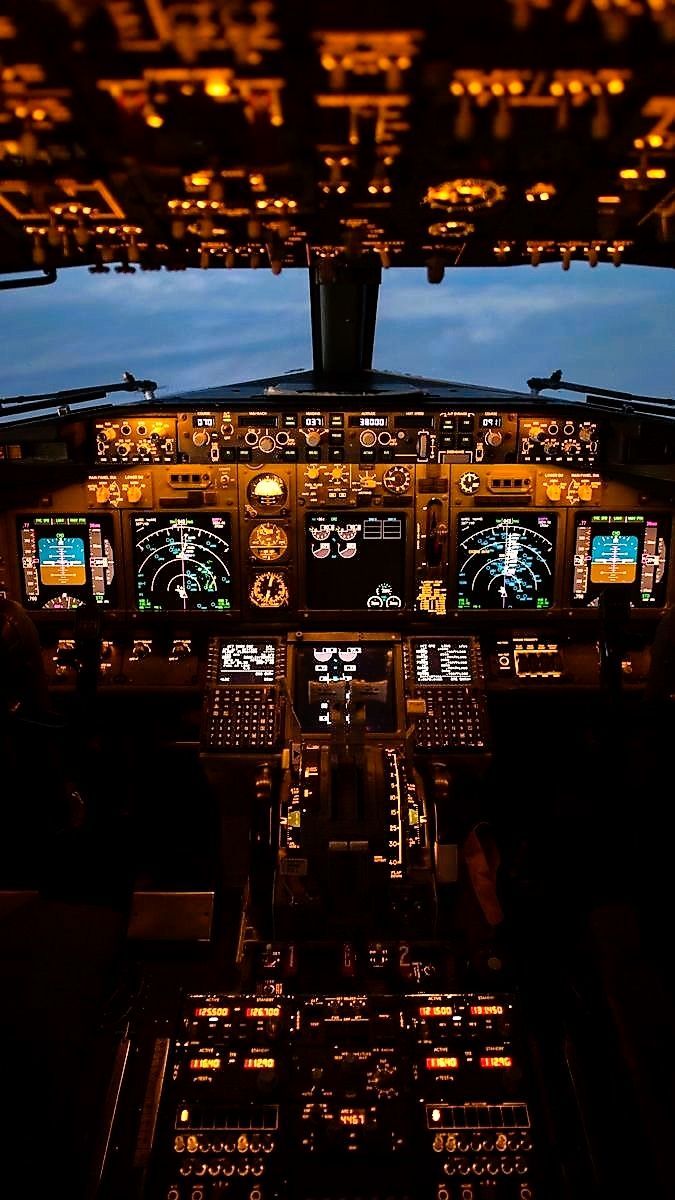 the cockpit of an airplane is lit up at night